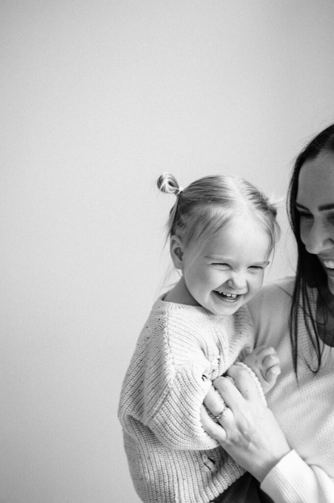 mom holding toddler during family photo session in Columbus, Ohio